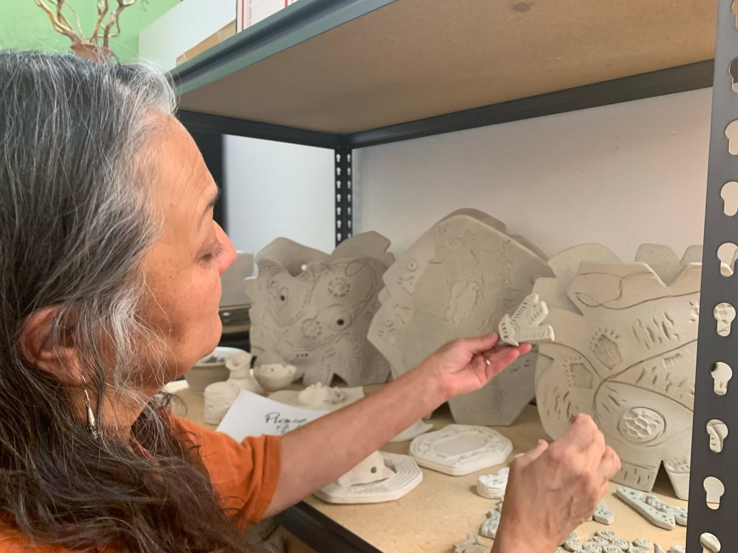 Clay artist Catherine Russo displays some of her work. Along the back wall are some of her current slab pieces.
