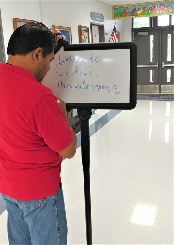 Central Elementary School P.E. teacher Tommy Esparza puts the finishing touches on a sign welcoming parents and students to the school for the new school year. Central Elementary Principal Sabina Aguilar said the school expects 185 K-5th graders to begin the 2022-23 school year.