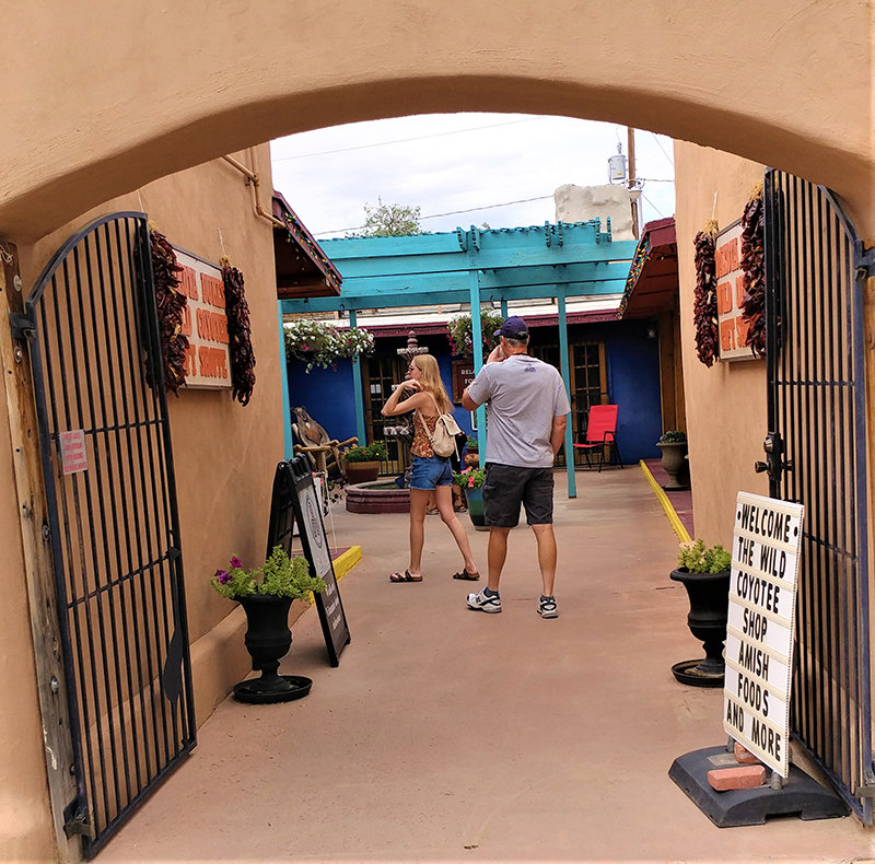Visitors entering the plaza that is home to the Wild Coyotee and the Candyman Can candy store.