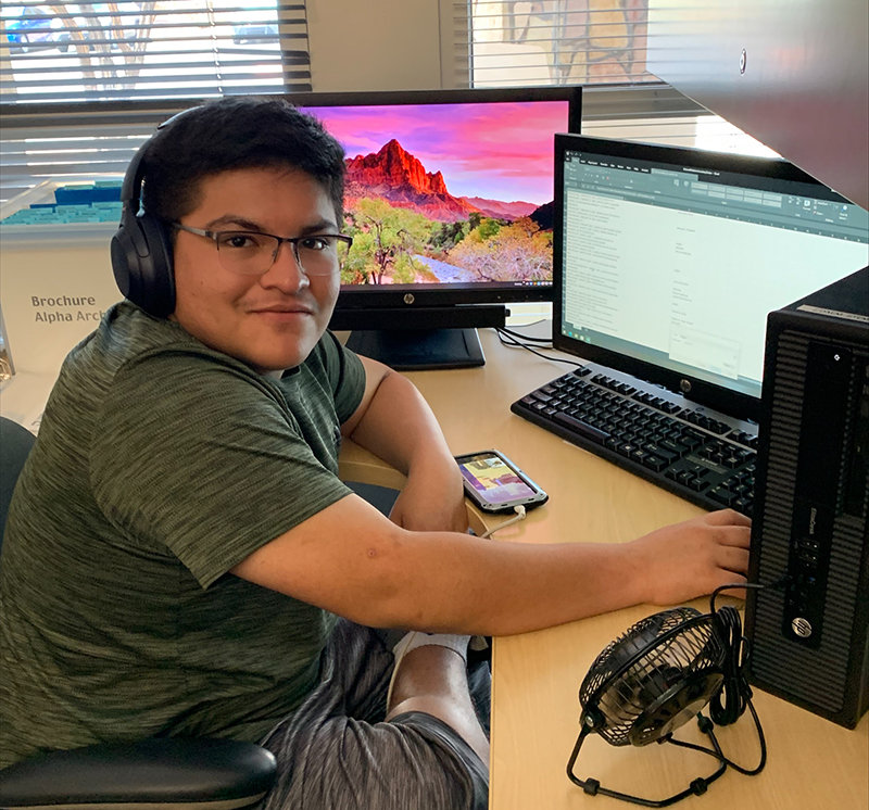 High school student Ivan Marquez assists the Doña Ana Community College External Relations office this summer with organizing documents for DACC’s 50th anniversary.