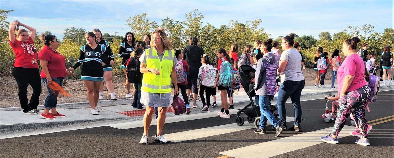 Las Cruces Public Schools’ Safe Routes to School Champion Maria Wagner helps Doña Ana Elementary School students, staff, parents and visitors get across the street during the school’s Sept. 13, 2022 International Walk to School Day Celebration – the school district’s first international walk event of the year.