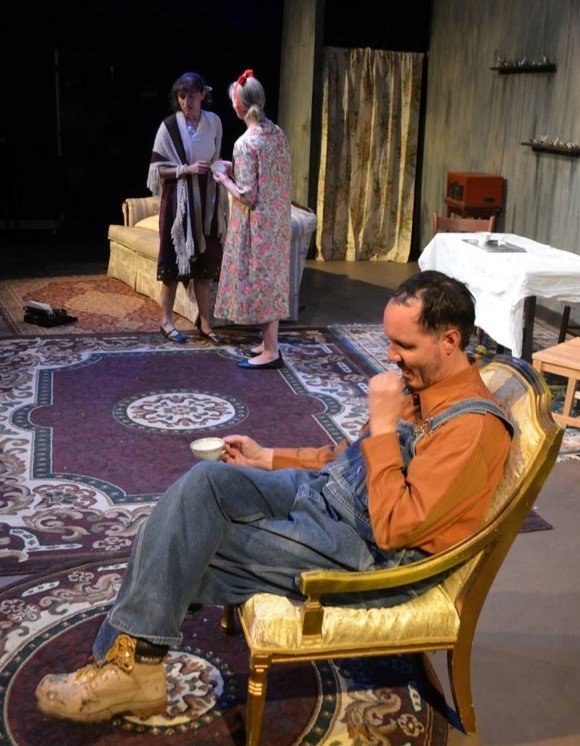 Darin Cabot as Tom Wingfield in Black Box Theatre’s production of “The Glass Menagerie,” with Casi Galban, left, and Karen Buerdsell in the background.