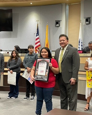 The City of Las Cruces Veterans Day Parade Poster Design Contest winner was Andrea Lugo, an eighth grader at Mesa Middle School. Shown here with Mayor Ken Miyagishima, Andrea and other poster artists were honored at the city council’s Oct. 3 meeting.