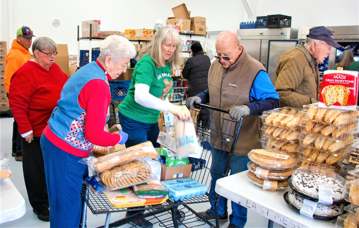 East Mesa Baptist Church volunteers prepare a good basket in the church’s new food pantry.