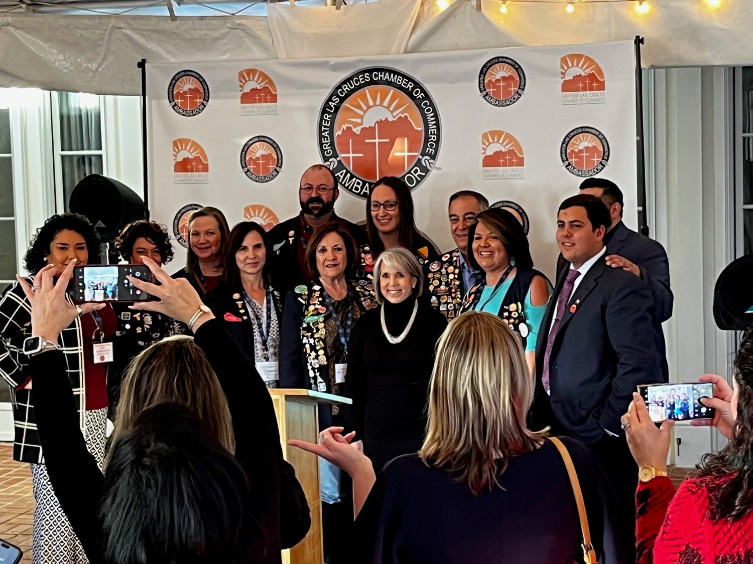 Members of the Greater Las Cruces Chamber of Commerce Ambassadors, who helped organize the event, pose for a photo with Gov. Michelle Lujan Grisham.