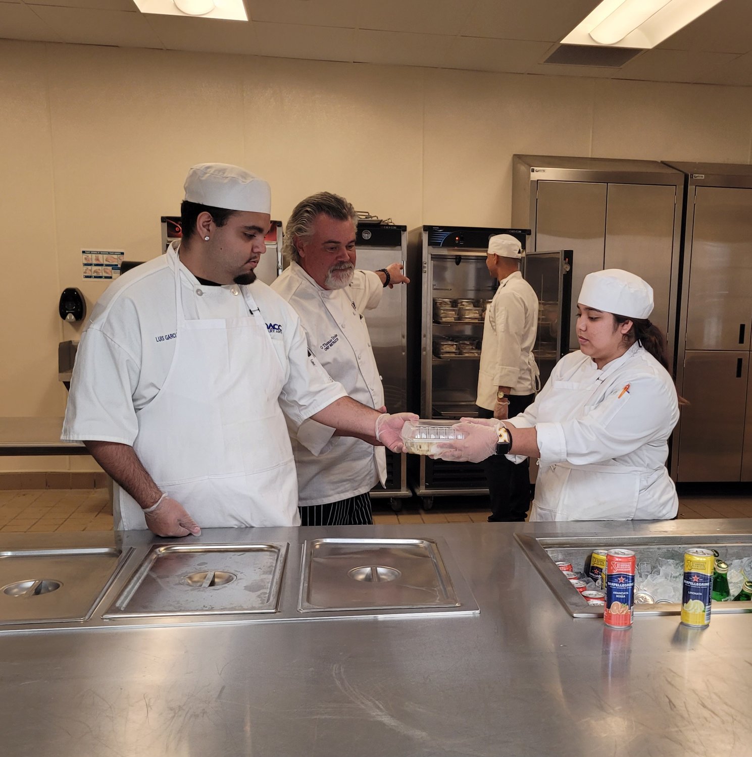 Doña Ana Community College chef instructor Tom Drake directs students on the flow of dinner service.