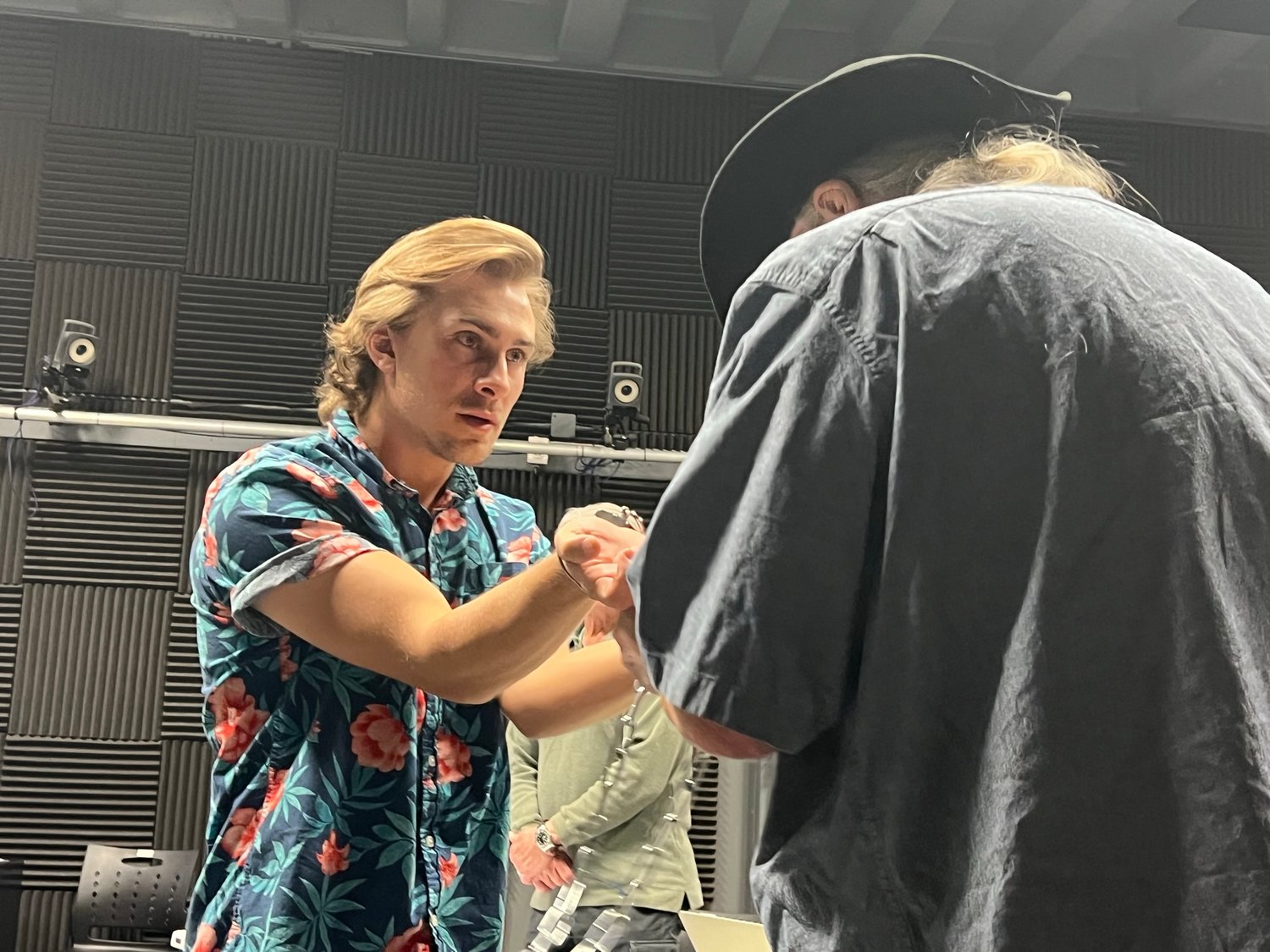 Billy the Kid (played by Nick Check) shakes his handcuffs at David G. Thomas who was filling in as a deputy during rehearsal of “The Trial of Billy the Kid,” as directed by NMSU Creative Media program director Ross Marks. Thomas is the author of the play.