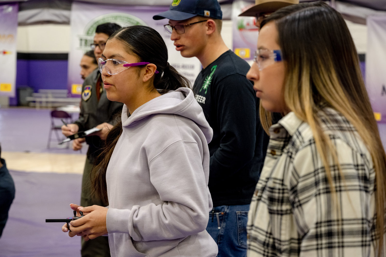 Paisley Pike, left, and Damaris Lent, Mescalero Apache High School students, navigate their drone through an obstacle course during the first Aerial Drone Competition at Mescalero Apache High School, Jan. 21, 2023. The 29th ATKS has had a long-running relationship with the Mescalero Apache tribe, using their Mascot the “Ghost Warrior” to affirm the heritage of the Mescalero Apache tribe. (U.S. Air Force photo by Senior Airman Antonio Salfran)