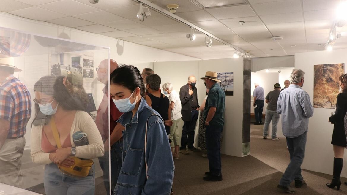 Visitors view artifacts in the Humanhood exhibition at the NMSU University Museum