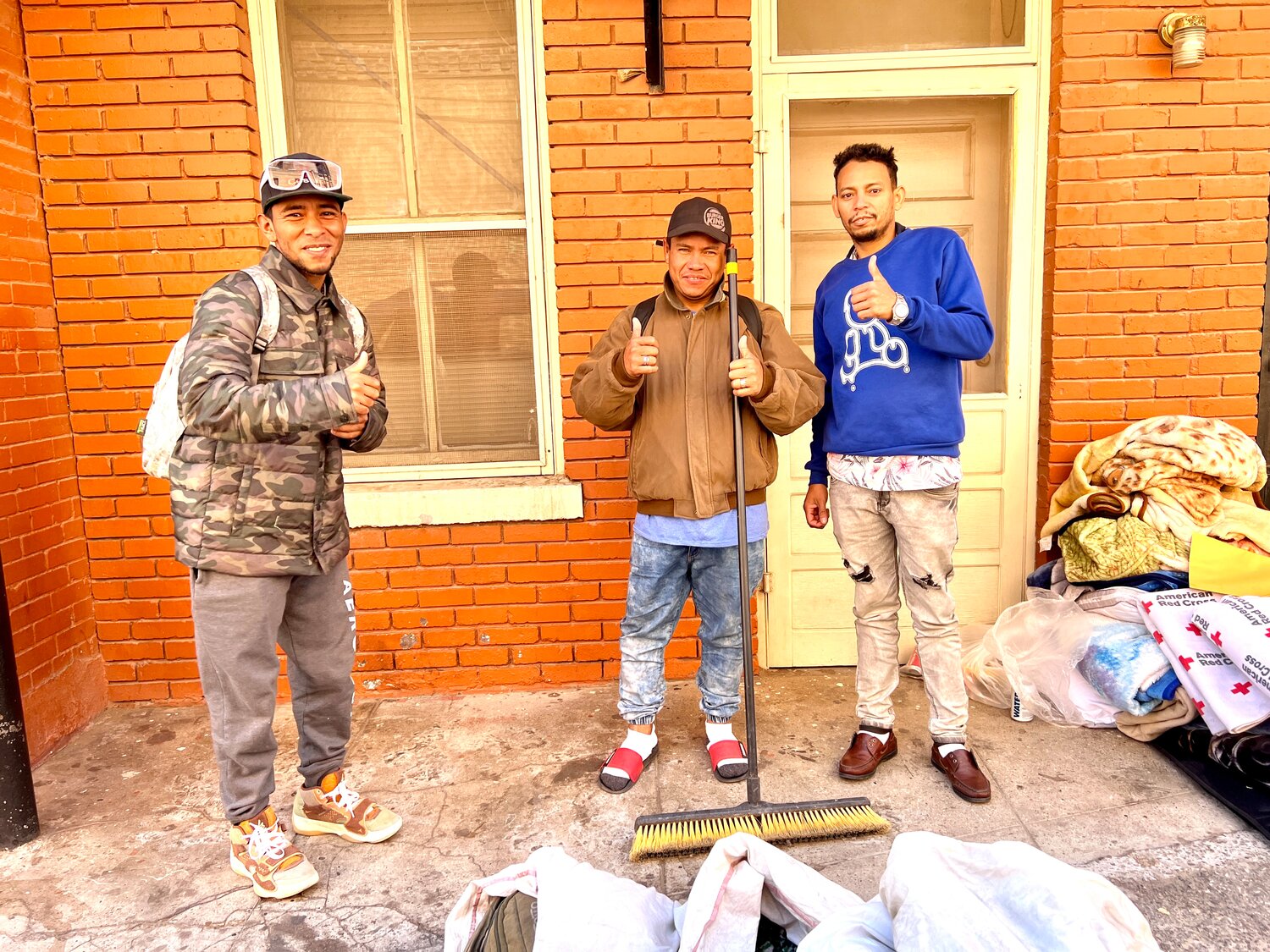 Three Venezuelans worked on cleanup at Sacred Heart church in El Paso, where some migrants stay