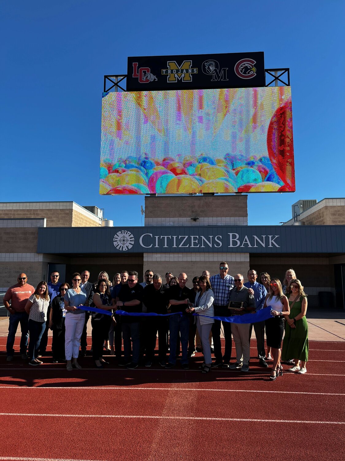 Representatives from LCPS and Citizens Bank gathered May 25 to cut the ribbon dedicating the new scoreboard at the Field of Dreams.