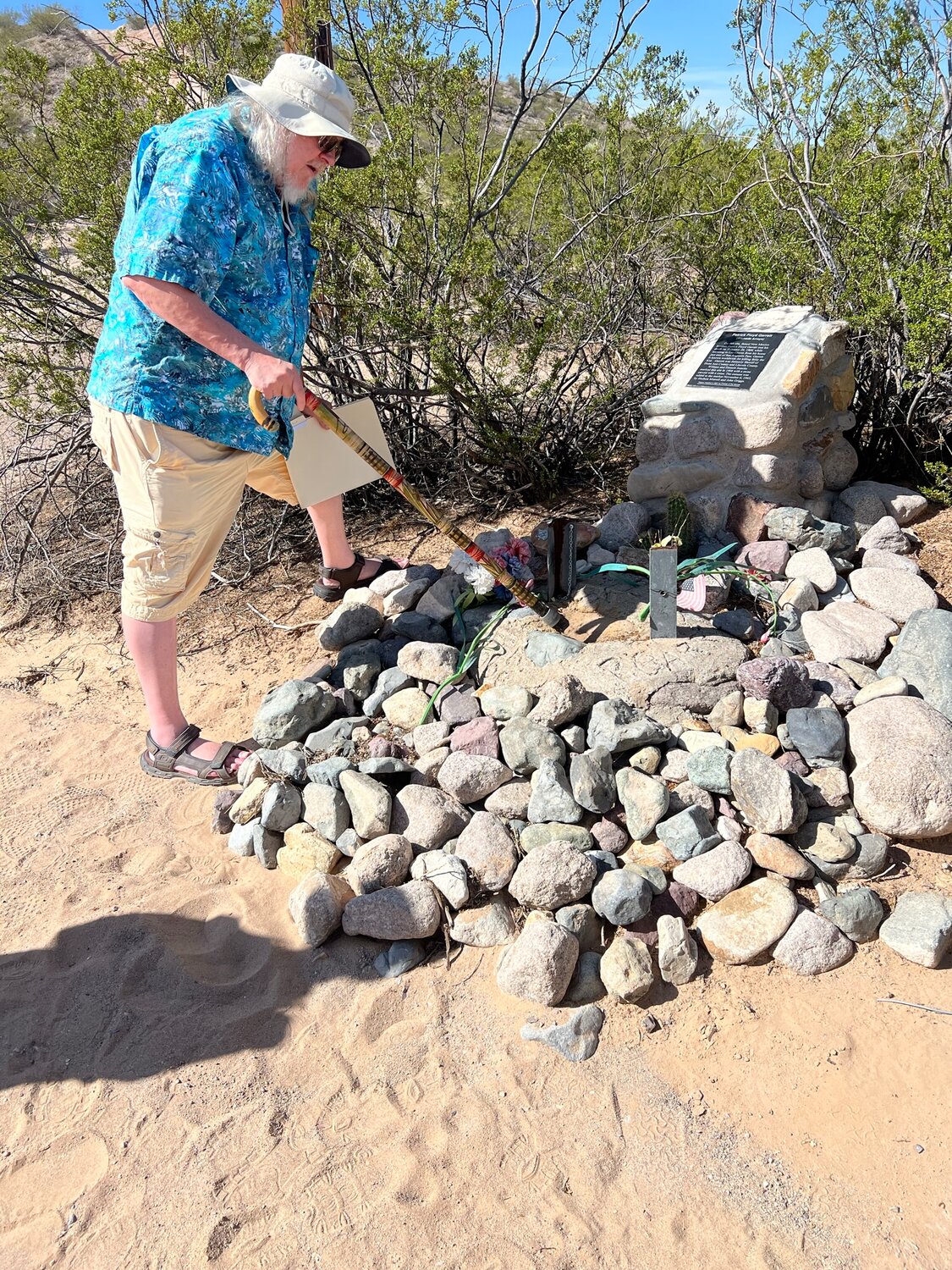 Historian Dave Thomas points out the original stone carved with a cross which marked the location Pat Garrett was killed.