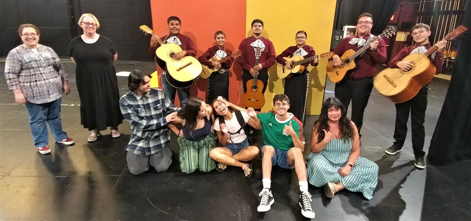 With NMSU mariachis in the background, led by Ken Tanuz, second from right, the cast and several crew members of “Carmela Full of Wishes” are, left to right, costumer designer Heather Striebel, production stage manager Bobbi Masters, Dominick Zimmerman (Papi), Eva Cullen (Mami), Karen Shaw (Carmela), Carlos Huereca (Big Brother) and the play’s director, Monica Mojica.