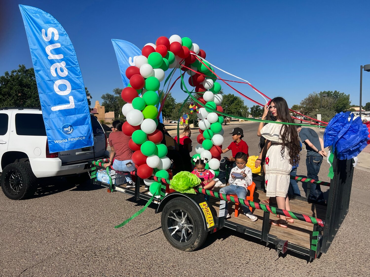 Celebrating Diez y Seis de Septembre, aka Mexican Independence Day, in Mesilla a parade prepares to make its way through the town on Saturday, Sept. 16. On the World Finance float, children and adults are ready to start well in advance of the event.