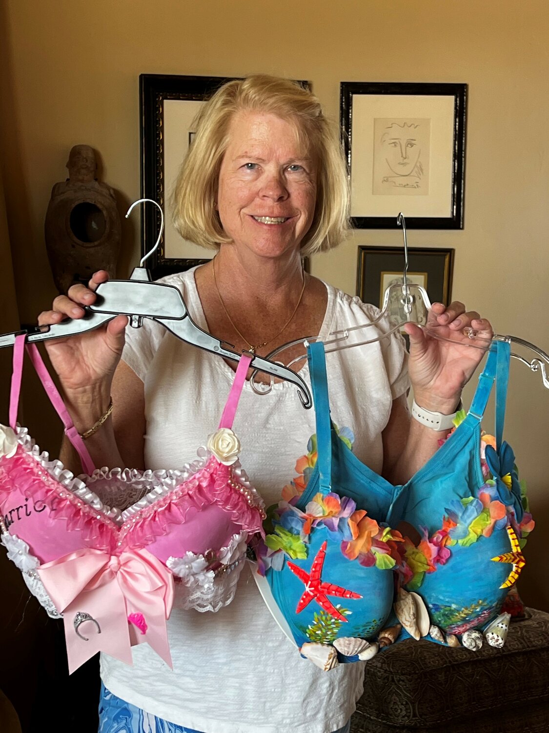 Kim Miller with her bra designs “Princess Warrior” and “Surf’s Up”