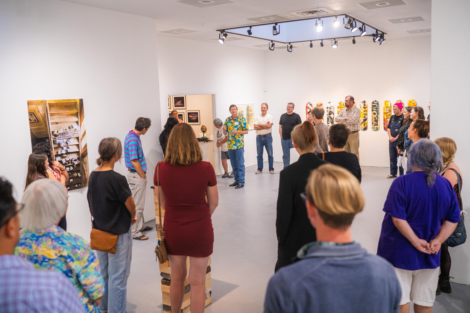 Professor of Sculpture and Expressive Arts Chair Michael Metcalf speaks to visitors at the faculty exhibition at the McCray Gallery of Contemporary Art, WNMU, Silver City, Oct. 19.