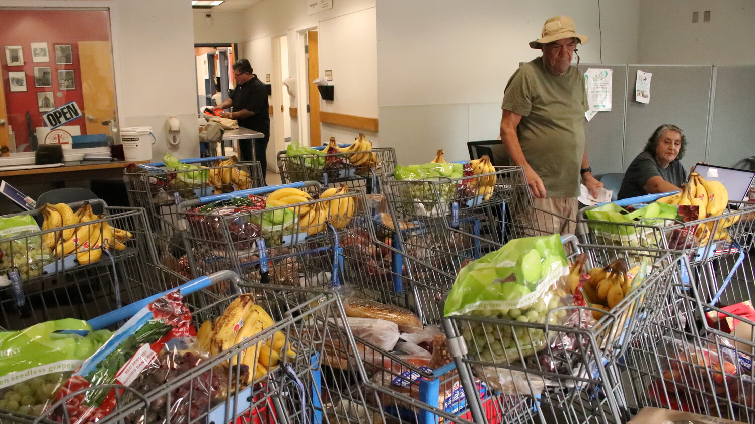 Volunteers work to distribute baskets of food to clients at Casa de Peregrinos emergency food pantry in Las Cruces, New Mexico in late July 2023. Advocates say they’re seeing more demand across Southern New Mexico for food assistance because of several factors, including a decline in COVID-19 relief programs and higher grocery store prices.