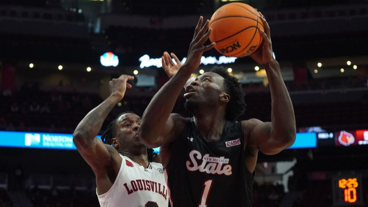 Kaosi Ezeagu goes up for a shot at Louisville during the Aggies’ overtime loss Sunday to the Cardinals. NMSU hosts University of the Southwest tonight at the Pan American Center.