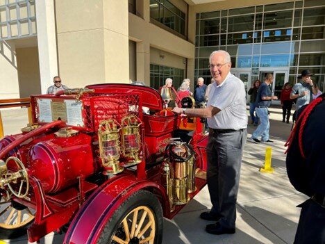 Wes Melo stands next to a 1915 Model T Ford fire engine that he restored and returned to the city of Las Cruces on Monday.