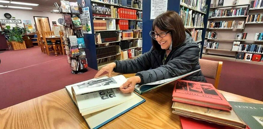 Magdalena Hinckley, a Utah resident spending the winter in southern New Mexico, visits the Hatch Public Library on Thursday, Jan. 25, 2024, to review yearbooks from the late 1960s. She attended Hatch schools through the seventh grade and says she’s glad the library had the books on hand.