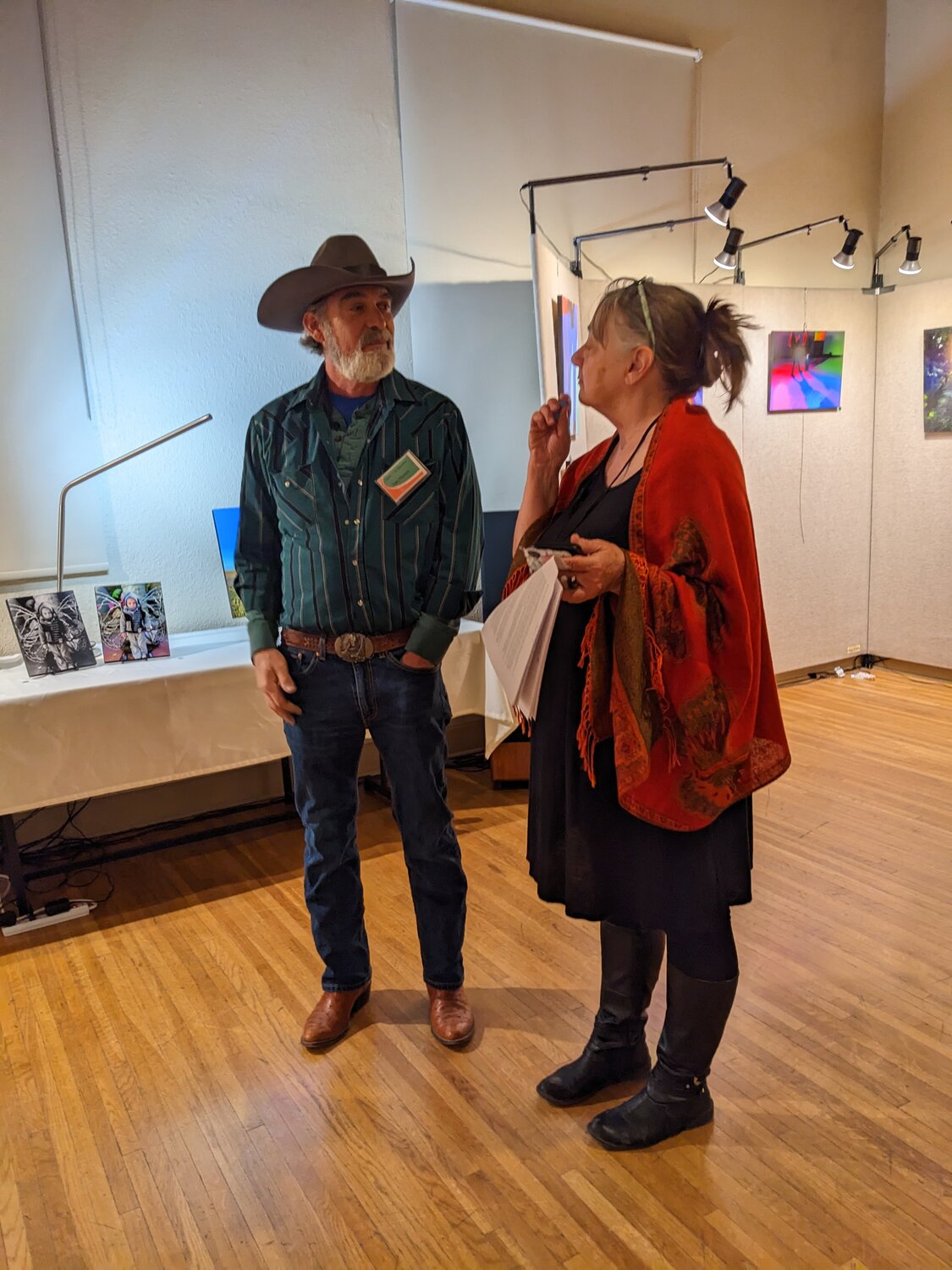Artist Dan Pilgreen chats with photographer Rochelle Williams during the opening of her exhibition, “A Poet’s Eye: Accidental Beauties.”