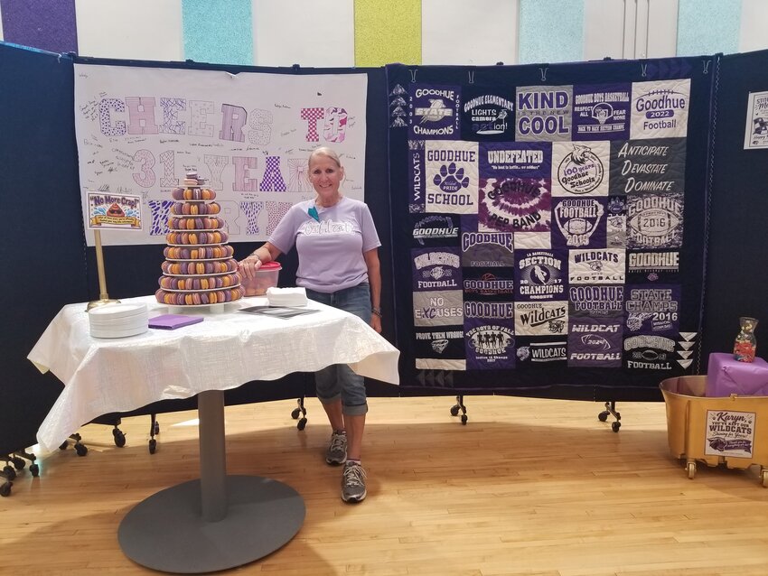 Karyn Edelbach Robertson stands among the gifts and treats organized by Goodhue school staff and employees for her retirement party. She served as the school's custodian for 31 years.