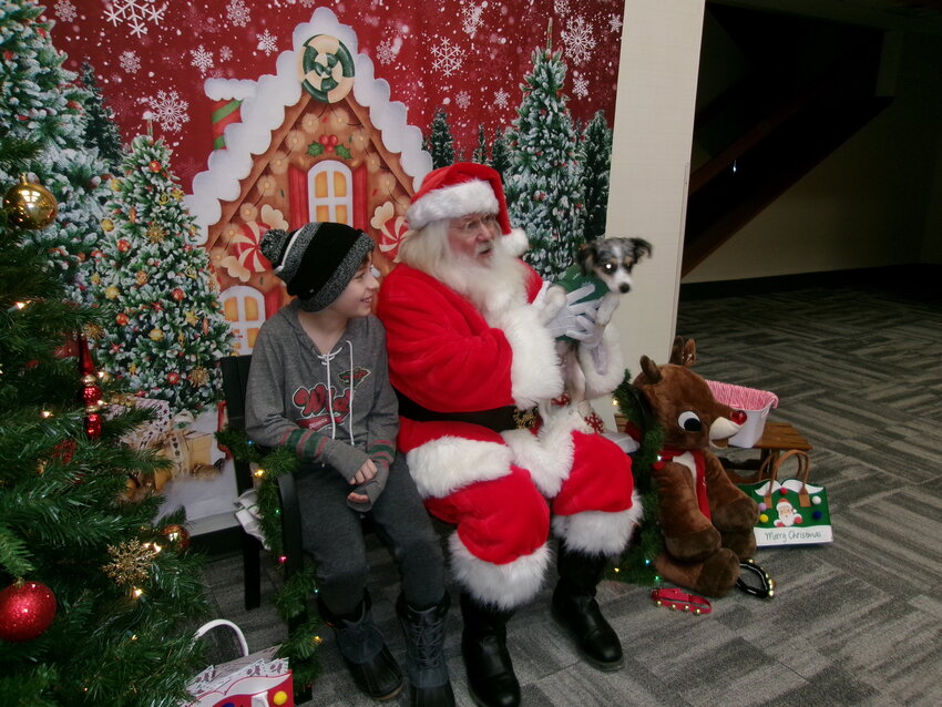 Santa at Security State Bank of Kenyon with kids and puppies
