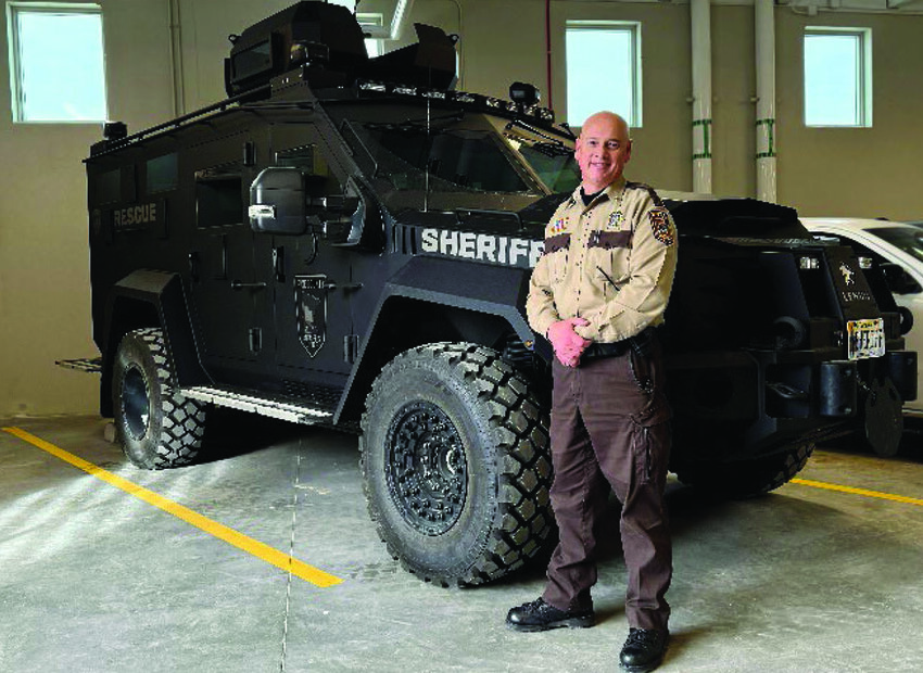 Sheriff Jesse Thomas stands in front of the new tactical 
armored vehicle which will be available if called upon by 
the South Metro SWAT.