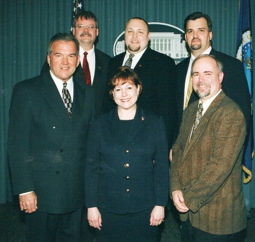 This picture from USDA headquarters was taken in 2003. Front row l to r: Homeland Security Secretary Tom Ridge, Ag Secretary Ann Veneman, Farm Broadcaster Ron Hayes. Back row l to r: Emery Kleven, Tom Brand, Jeff Nalley.
