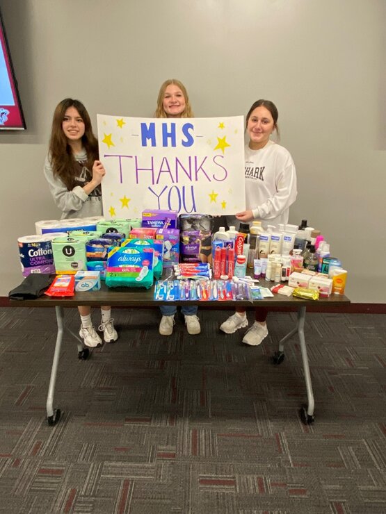 Pictured (from left to right) are MHS members Camila Medina Romero, Olivia Weber, and Macy Klejeski displaying the array of donations received