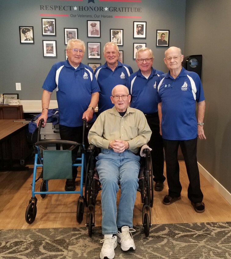 Goodhue Living resident, Robert Seeley is seated in front of the Lakelanders Men's Chorus who sang barbershop quartet-style songs for a group of about 25 guests.  Having sung in a Rochester men's chorus for over 50 years, Robert knew the words to many of the selections.