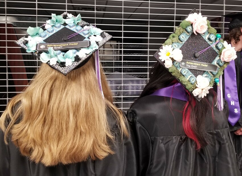 A couple of the few decorated mortarboards on graduation night.