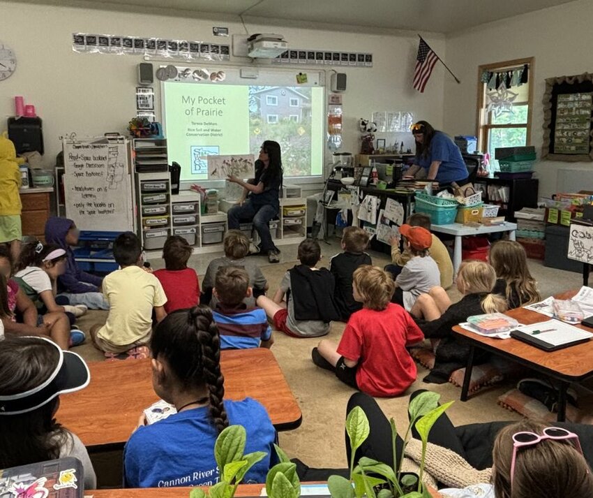 Rice SWCD Outreach Coordinator Teresa DeMars reads Plant a Pocket of Prairie to third-grade students at Cannon River STEM School in Faribault.
