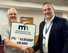 Mark Schoenfelder, MnDOT District 6 Transportation Engineer, right, congratulated Rice County Highway Engineer Dennis Luebbe who accepted the statewide Partnership Award last week on the county&rsquo;s behalf