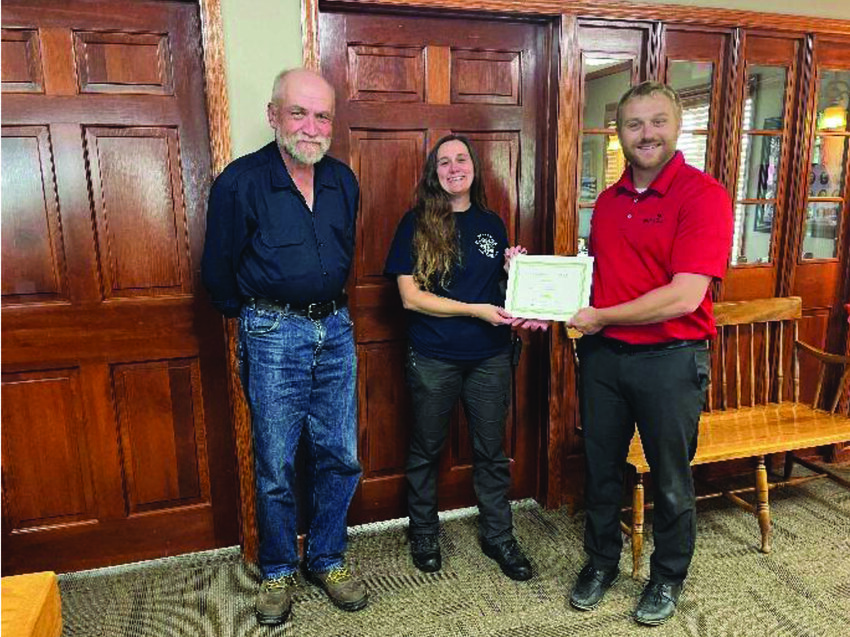 DCCF President Tom Monson and Treasurer Jim Checkel   present EMT scholarship certificate to Crystal Heim