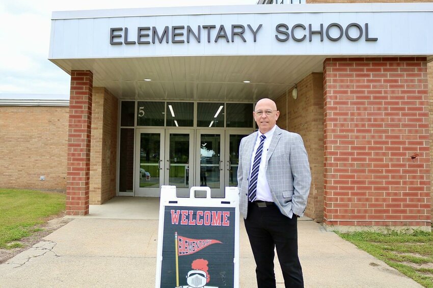 Patrick Heiderscheit stands in front of Kenyon-Wanamingo's Elementary School.