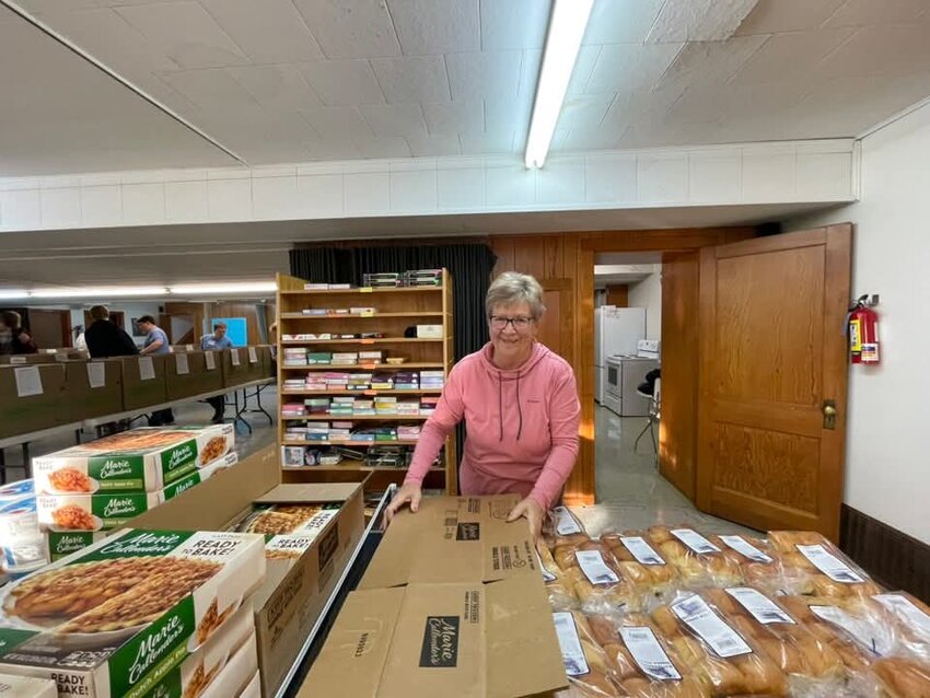 Diane Opsahl sorts items for the Community Help Network Thanksgiving baskets.