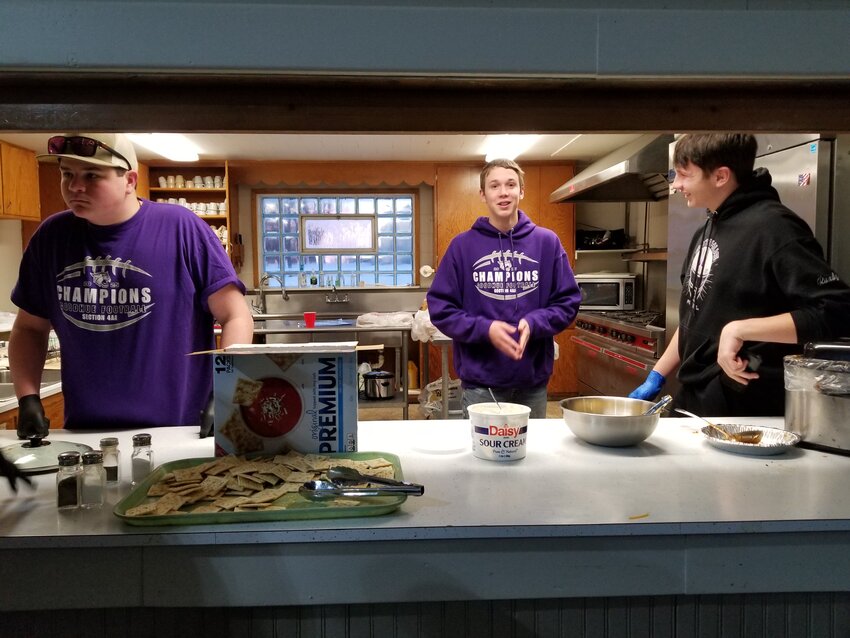 Members of the Goodhue High School trap team served chili and sweet rolls during the Bellechester holiday event that raised funds for their team.