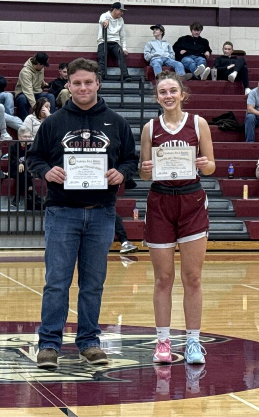 Henry McMartin and Rainey Dobbs accept their awards at the girls' basketball game.