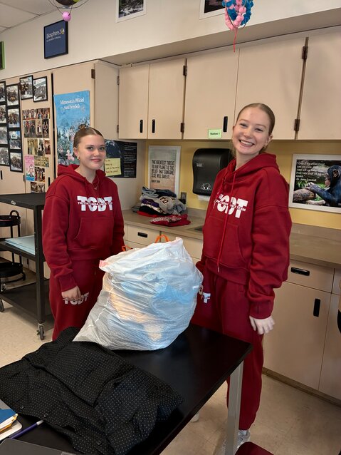 Kayleah Dupey and Jessica Hukee sorting clothes