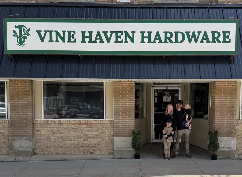 Kyle and Elia Poncelet and children, Ayven and Novah outside their newly opened Vine Haven Hardware store.