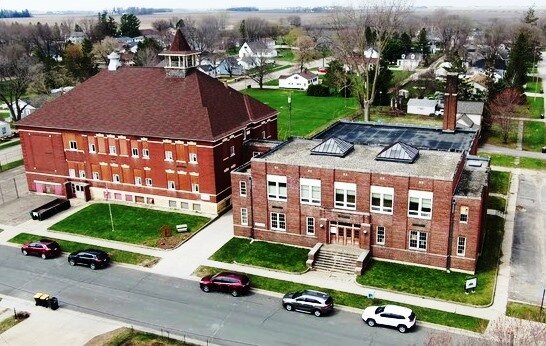 Collaborative Design Group, Inc. of Minneapolis used a drone to take this photo in the process of drawing up Construction Plans for replacing the roof in the gymnasium building on the right.