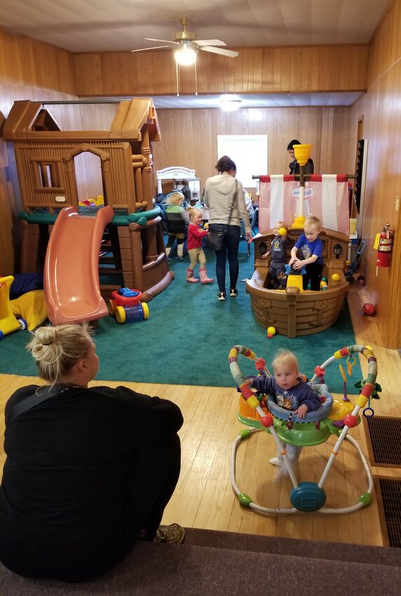 Parents supervise their children while they enjoy a play area inside The Sanctuary on April 11th.