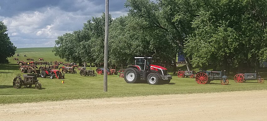 A new model Massey Ferguson tractor provided by Lodermeier Implement stands amidst an array of older machines displayed across the Joe and Jo-Jo Poncelet farm when they hosted the 2026 Massey Collectors Summer Reunion show.
