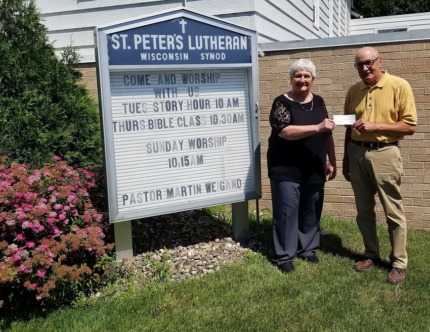 St. Peter&rsquo;s Lutheran Church Ladies&rsquo; Aid treasurer, Carol Voth presents a check for $1200.00 to Dean Opsahl, representing the Community Help Network.  The Community Help Network helps local people in need.  The money was raised during the church-sponsored burrito breakfast during Volksfest.