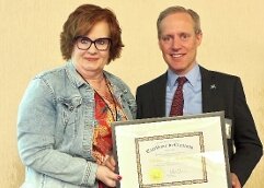 Minnesota Secretary of State Steve Simon presents Denise Anderson, Rice County Property Tax &amp; Elections Director, with an award for outstanding work in elections.