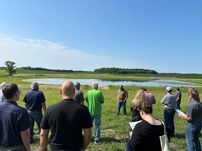 Mike Schultz, Le Sueur SWCD, explains the benefits of a recently completed 37-acre wetland restoration and storage project in Le Sueur County during the Cannon River Watershed Joint Powers Organization&rsquo;s conservation tour.