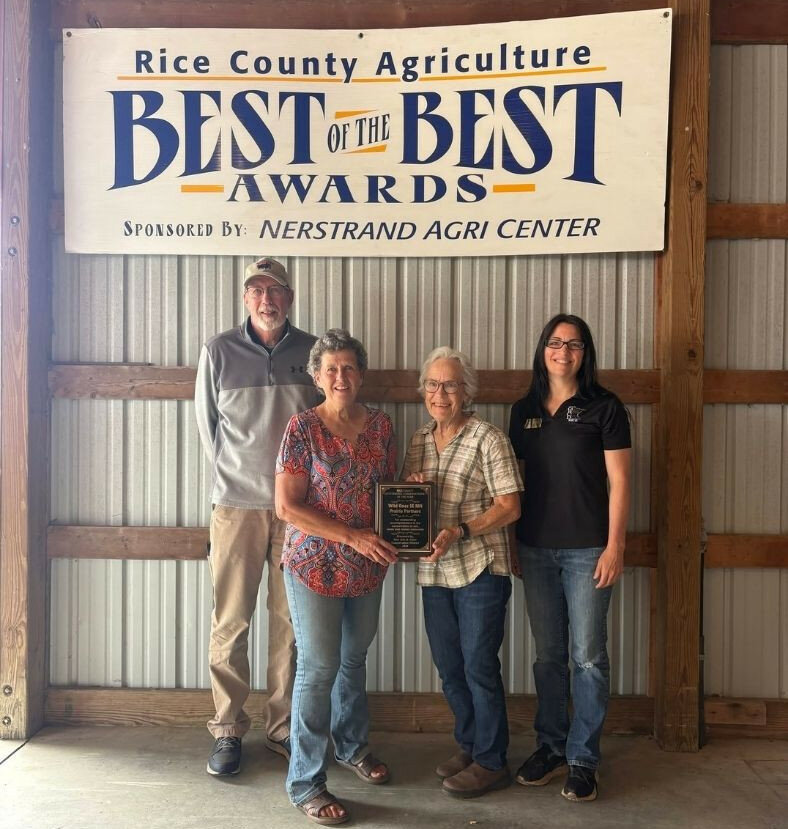 Barb Bolan and Nancy Schumacher receive the Outstanding Conservationist Award from the Rice SWCD at the Best of the Best Ag Awards at the Rice County Fair. From left to right: Richard Peterson (Rice SWCD Supervisor), Barb Bolan, Nancy Schumacher, Teresa DeMars (Outreach Specialist, Rice SWCD).