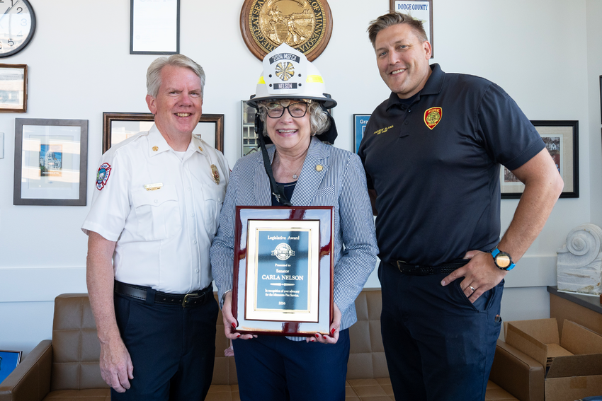 Sen. Nelson receives a plaque from White Bear Lake Fire Chief Greg Peterson (left) and Edina Fire Chief Andrew Slama (center)