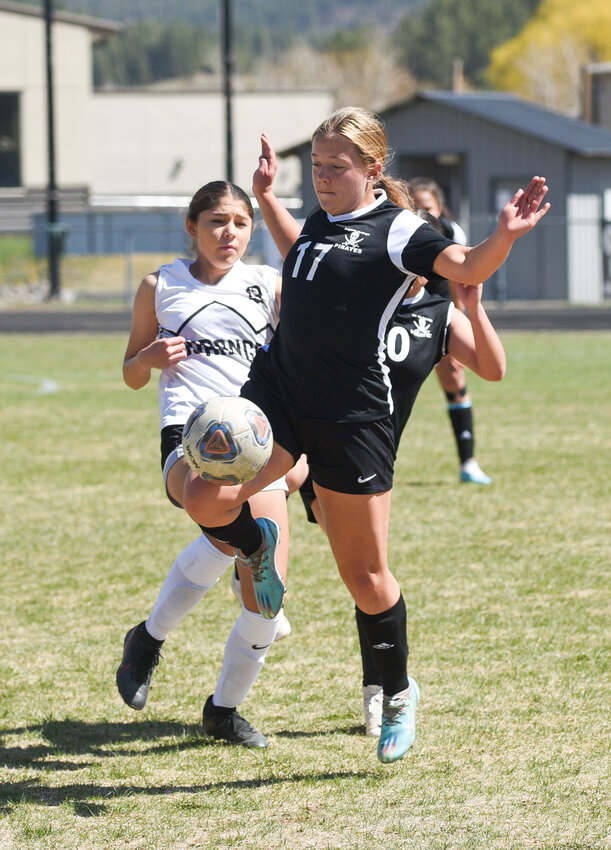 Lady Pirate Adison Johnson takes the ball out of the air during a game against the Durango Demons junior varsity on April 20. The Lady Pirates scored once each in the first and second halves to win the game.